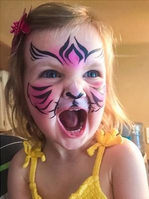 tiger face paint on young girl